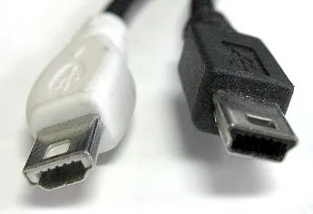 Close-up of two USB mini-B plugs, one white and one black