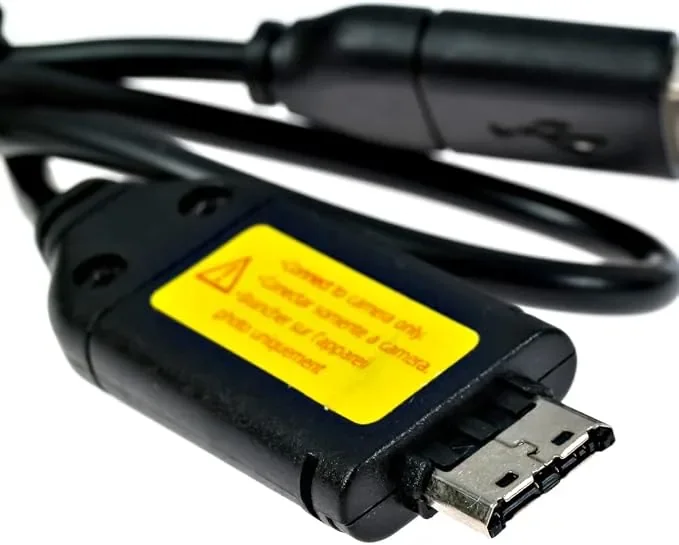 A Samsung camera plug with a yellow caution label