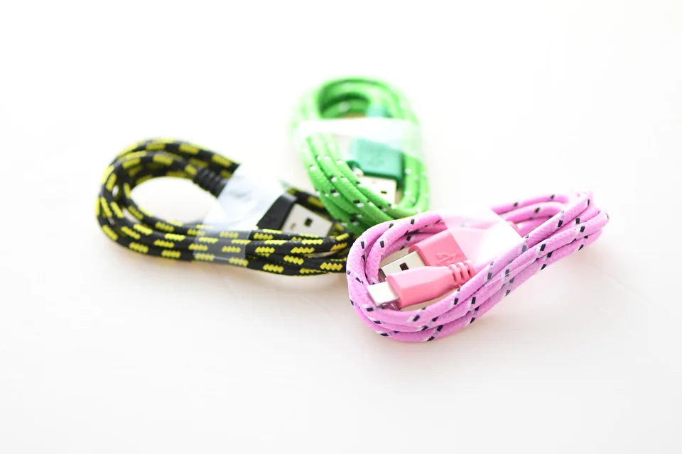 Three braided USB cables in yellow, green and pink