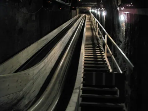 A dim wooden slide in a salt mine, photographed with this camera