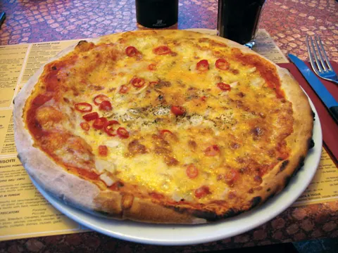 A pizza on a table, photographed with this camera
