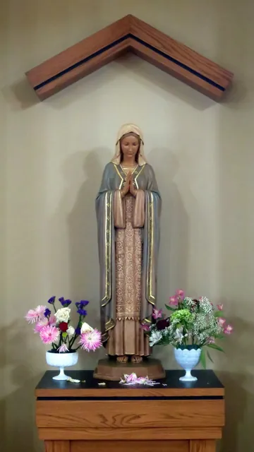 A church statue with flowers
