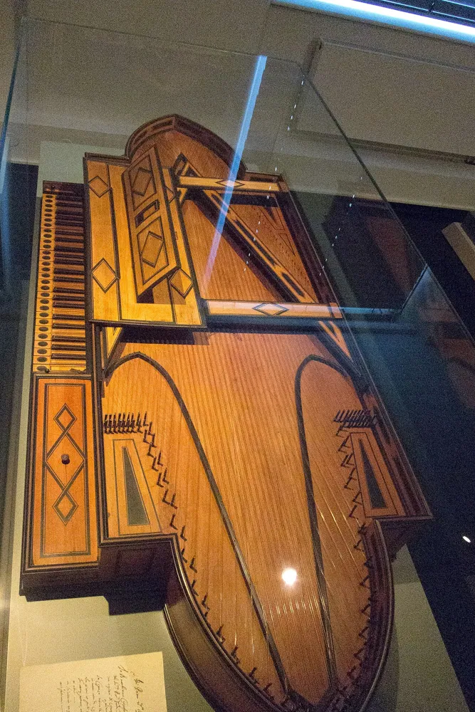An early keyboard instrument in a dim gallery, at ISO 3200.