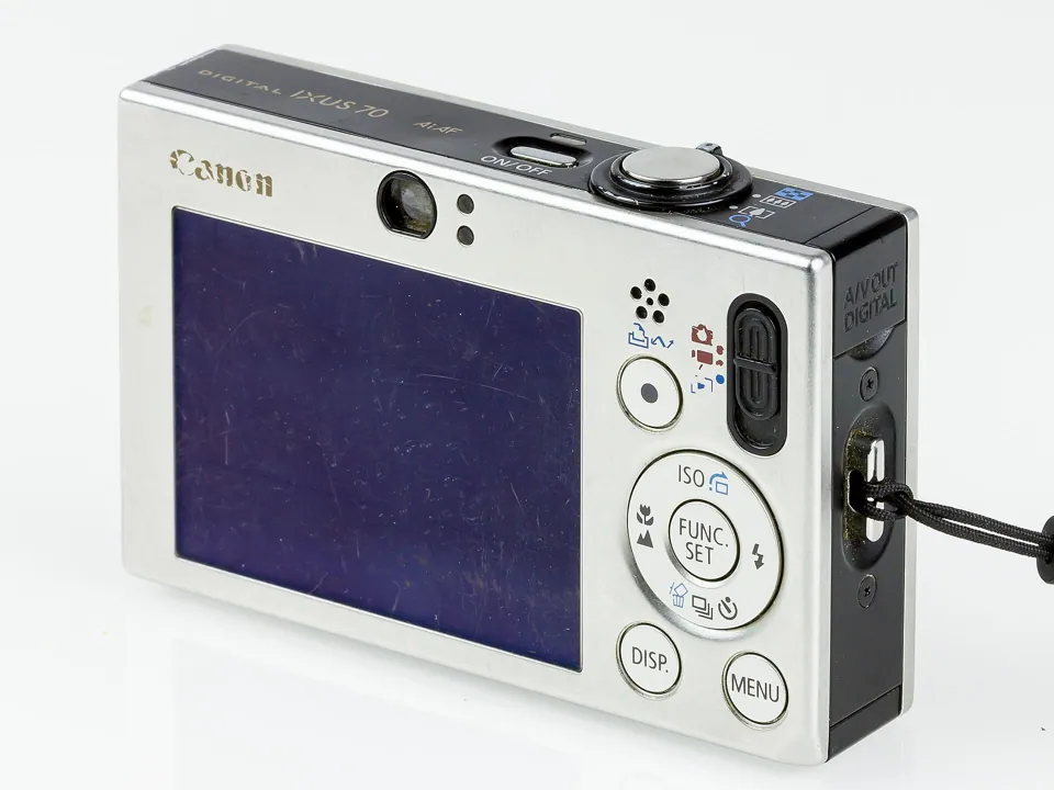 The back: a 2.5-inch screen, a ring of buttons around FUNC/SET, and a small optical viewfinder window above.