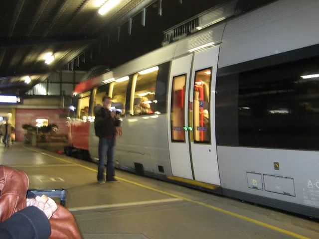 A lit tram in a dim station