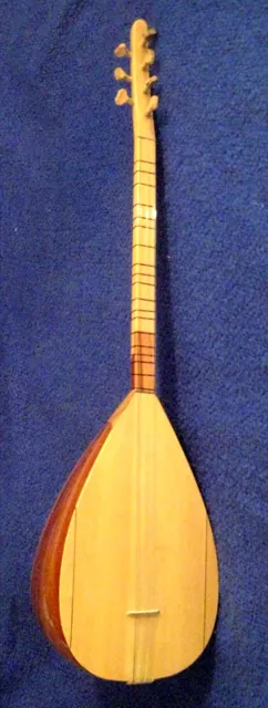 A lute-like saz under museum lights