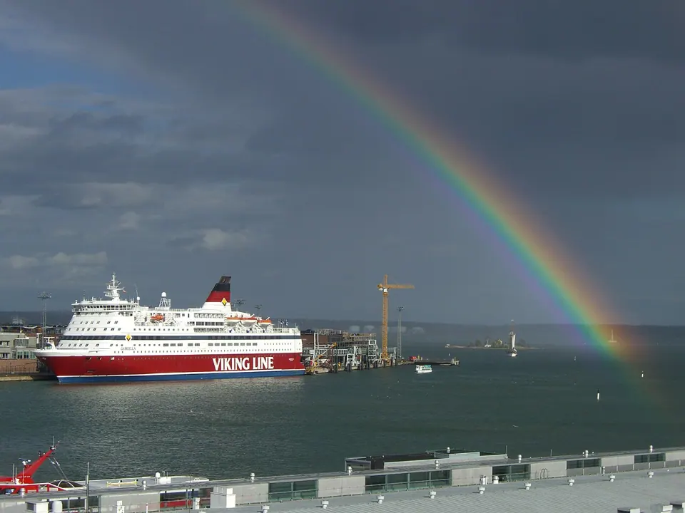 A ferry and a rainbow in Helsinki harbour, photographed with a Casio Exilim EX-Z1000. We found no usable free photo of the camera itself.
