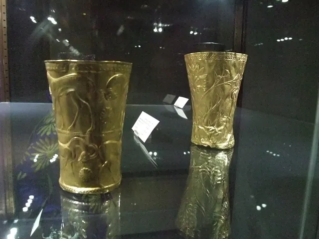 Two gold cups in a lit case