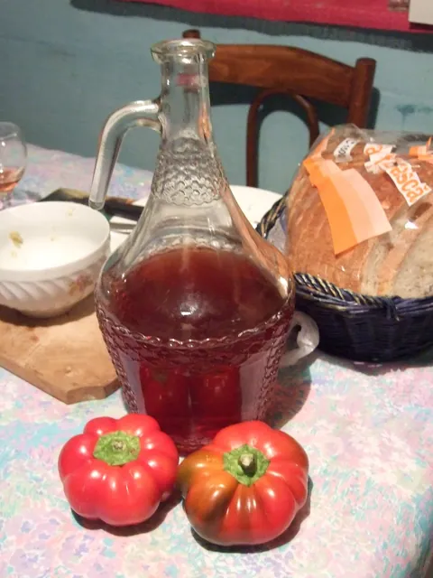 A bottle and peppers indoors