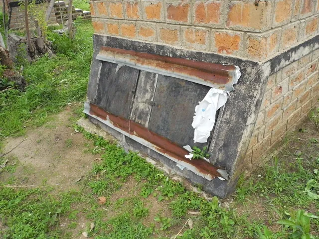 A metal door set into a brick wall