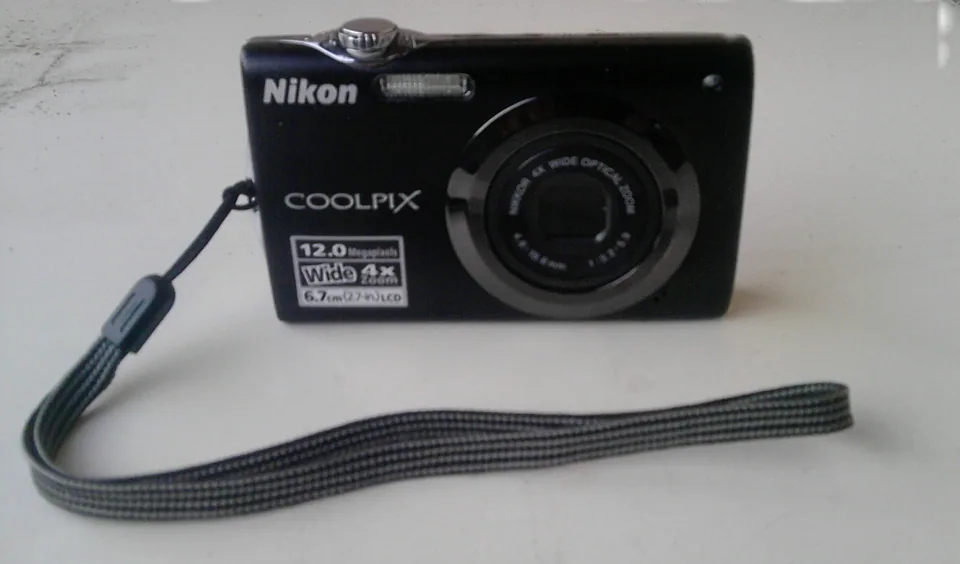 The Nikon Coolpix S3000 in black, with its wrist strap.