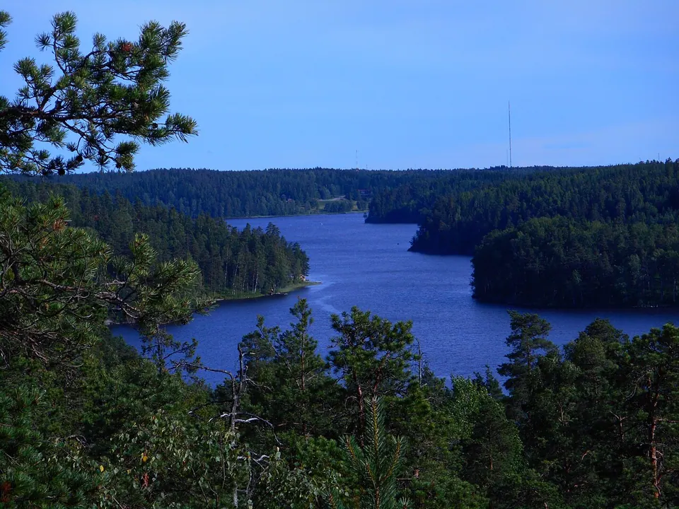 A lake in Nuuksio National Park, Finland, photographed with a Nikon Coolpix S3700. We found no free-licence photo of the camera itself.