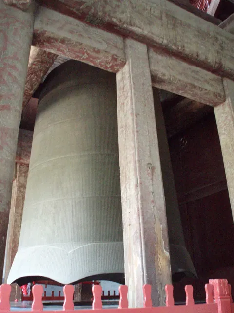 A large bell in a wooden frame