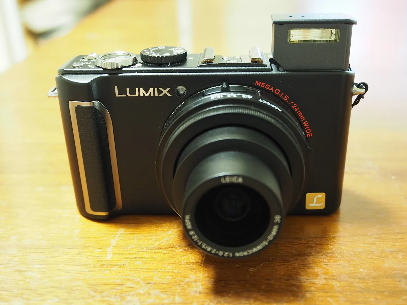 The Panasonic Lumix DMC-LX3 with its pop-up flash raised.