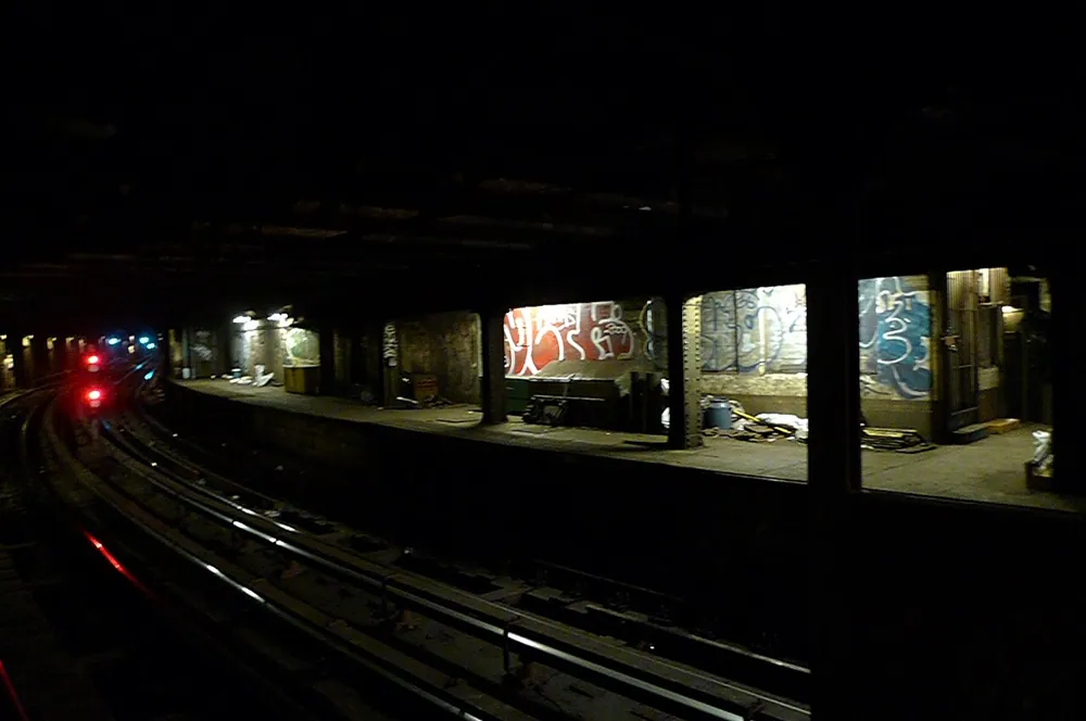 A dark disused station platform, handheld at ISO 800.