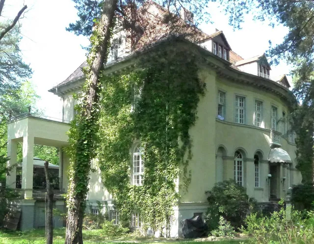 A villa behind trees