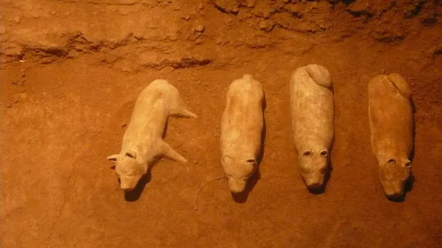 Clay figures in a dim museum