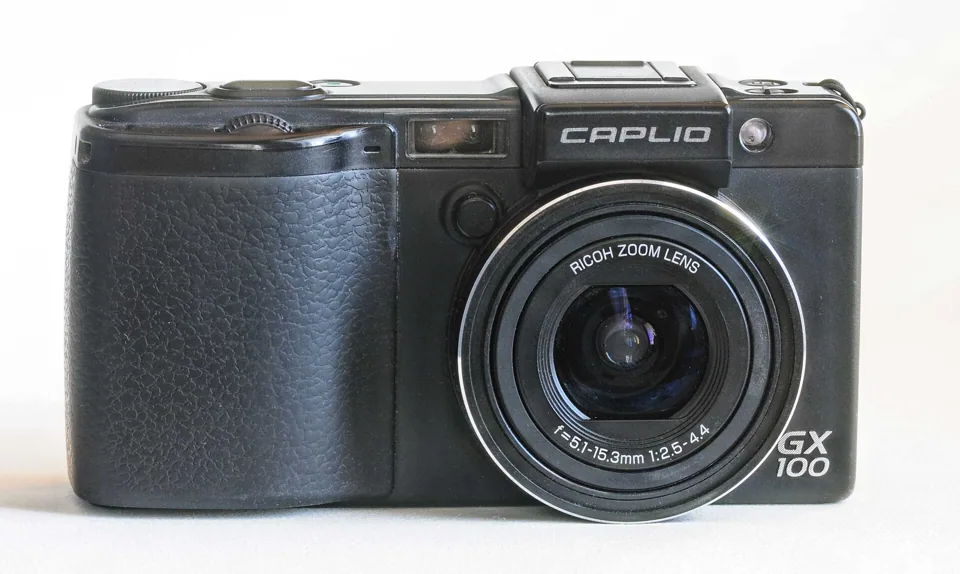 The Ricoh Caplio GX100 in black, front view.