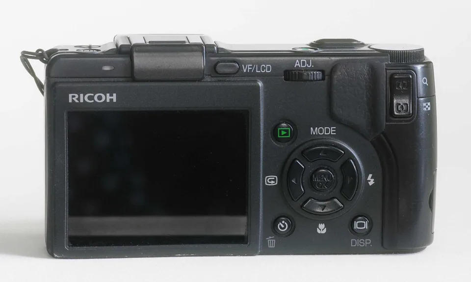 The back of the GX100, with its 2.5-inch screen and control dials.