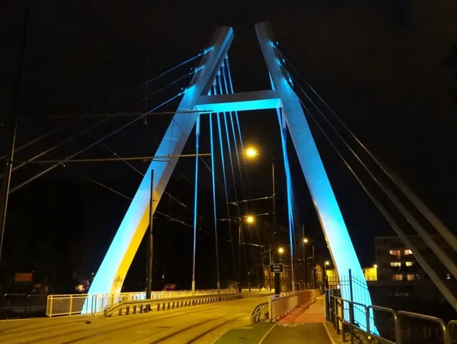 A bridge lit blue at night
