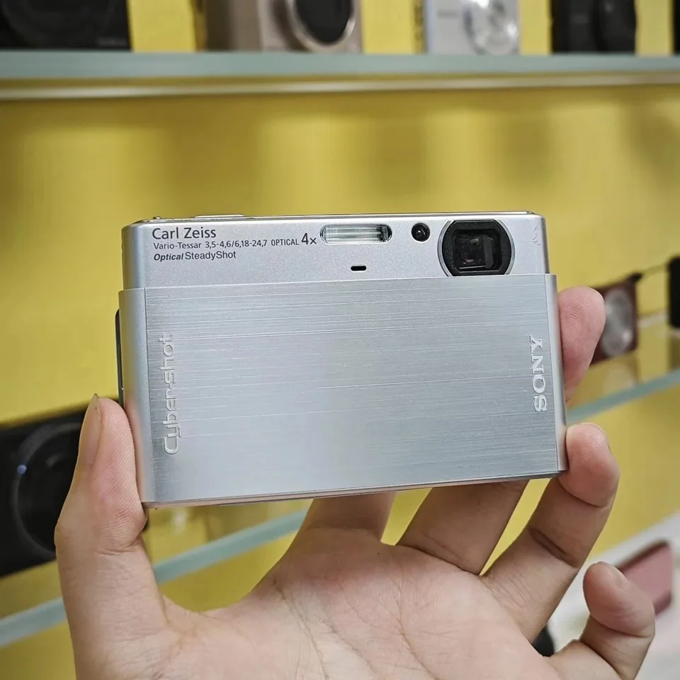 The Sony Cyber-shot DSC-T77, front, with the slide cover half open.