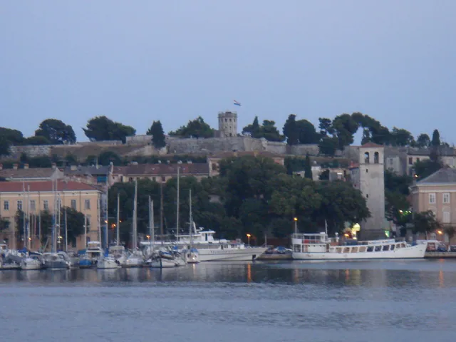 A fortress seen from a boat at dusk