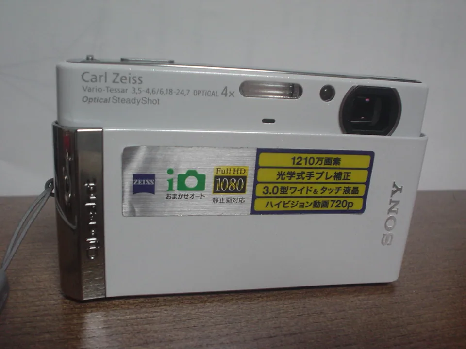 The Sony Cyber-shot DSC-T90 on a shop shelf in Japan, with its sliding lens cover half open.