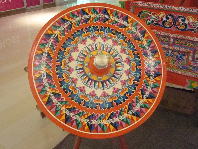 A painted cart wheel indoors
