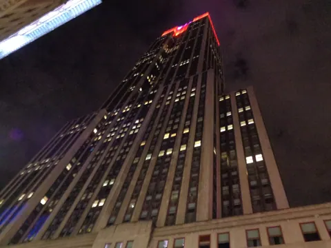 A tall lit building at night, photographed with this camera