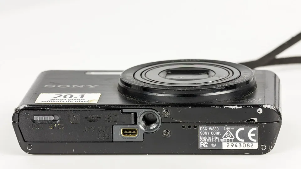 The underside of the W830: battery and card door, tripod socket and the USB / A/V OUT socket.